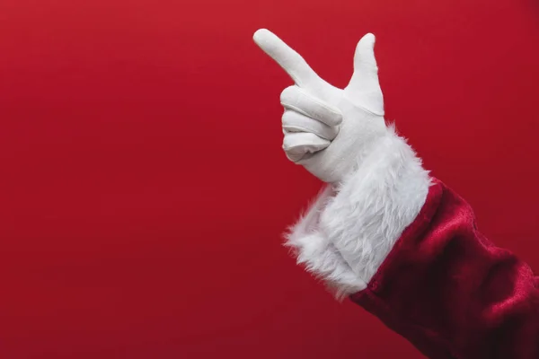 Święty Mikołaj wskazując palcem na czerwonym tle — Zdjęcie stockowe
