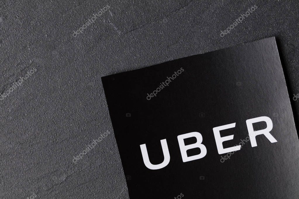 A photograph of  the Uber logo. Uber is a popular taxi style transport service application, founded in 2009