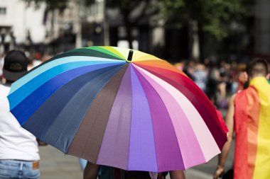 Gay rainbow flag umbrella at an LGBT gay pride march in London