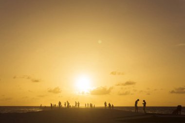 KURAMATHI, MALDIVES - JUNE 2017: People gather on the beach to w