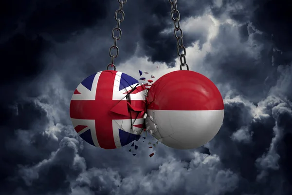 United Kingdom and Indonesia flag political balls smash into eac — Stock Photo, Image