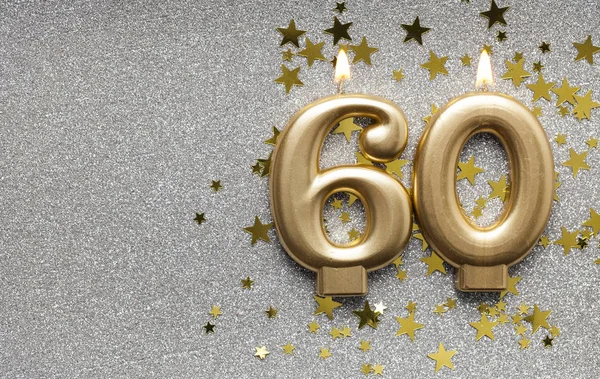 Number 60 gold celebration candle on star and glitter background — Stock Photo, Image