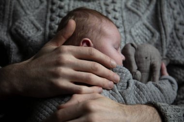 Oğlunu göğsünde tutan bir baba. Aile bağı. Babalık