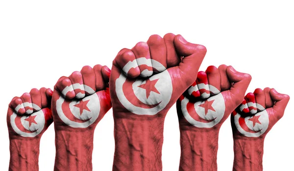 A raised fist of a protesters painted with the Tunisia flag — Stock Photo, Image