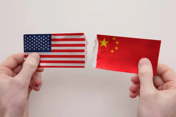 USA and China paper flags ripped apart. political relationship concept