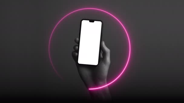 Hand holding modern smartphone with a blank white screen and neon light glow — Stock Video