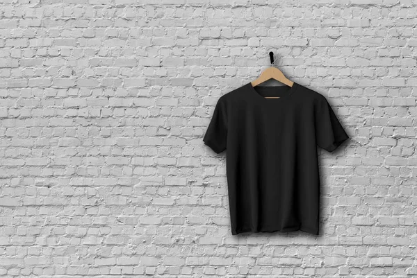 Black t-shirt mock up hanging against a brick wall 3D Rendering
