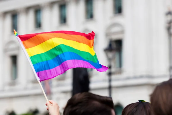 Orgulho gay, bandeiras do arco-íris LGBTQ sendo acenadas no ar em um evento de orgulho — Fotografia de Stock