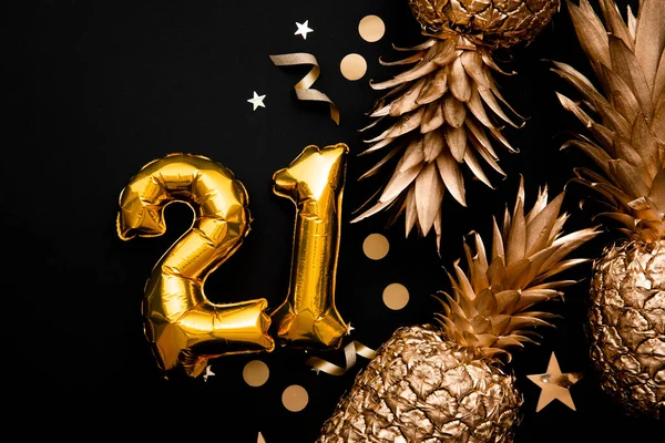 21st birthday celebration background with gold balloons and golden pineapples — Stock Photo, Image