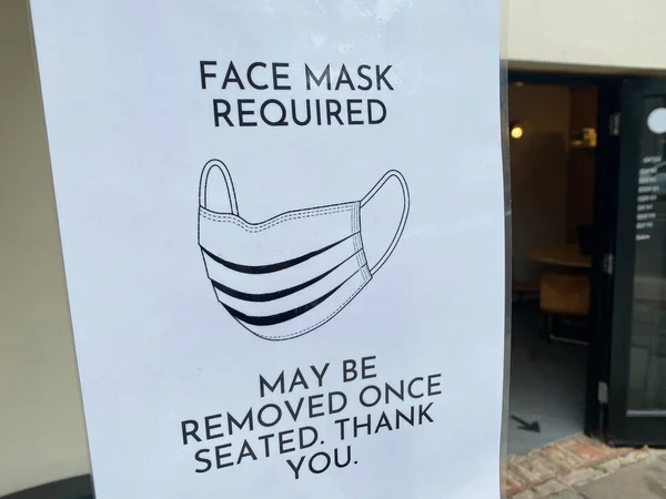 Skyddande ansiktsmask krävs skylt utanför restaurang — Stockfoto