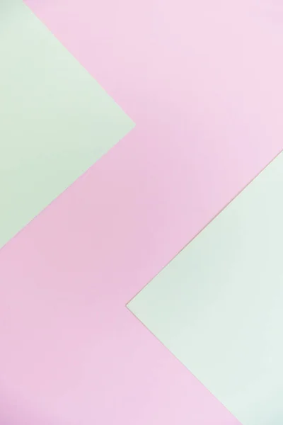Abstract pastel green and pink pastel color paper geometric flat lay background. Minimal geometric shapes and lines in pastel colours.