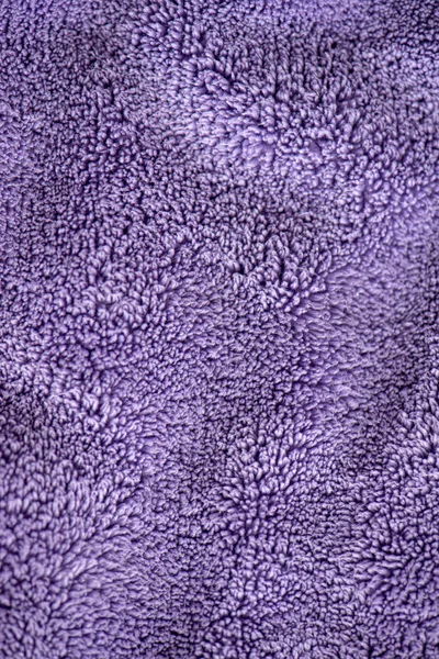 Lilac delicate soft background of fur plush smooth fabric. Textu