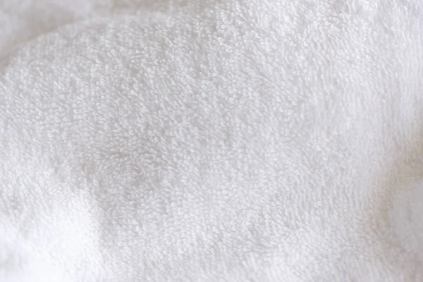 White delicate soft background of fur plush smooth fabric. Clean white tarry towel blanket textile