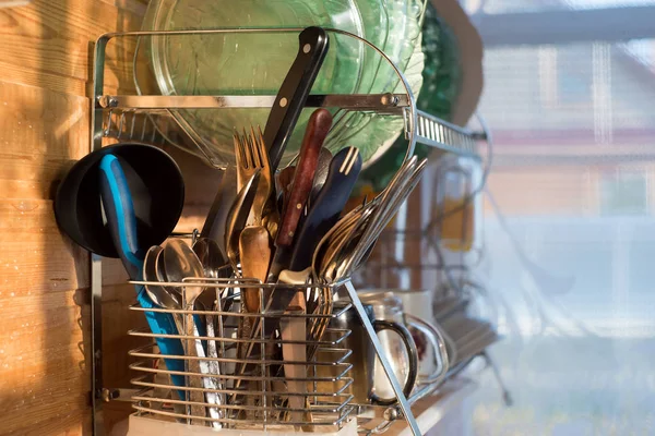 Clean cutlery in the dishwasher. Home equipment. Work at home concept.