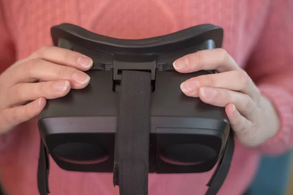 close up of adjusting virtual reality goggles