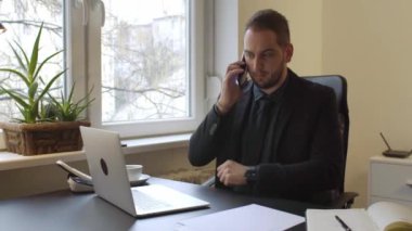 laptop pencere siyah tablo defter kağıtları telefon yönetici şirket ile sinirli ve öfkeli telefon görüşmesi yapma ofiste çalışan iş adamı
