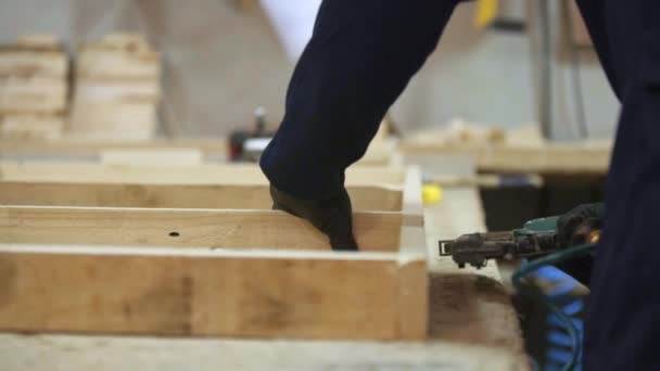 Young Man Dark Coat Puts Together Wooden Pieces Sofa Stapler — Stock Video