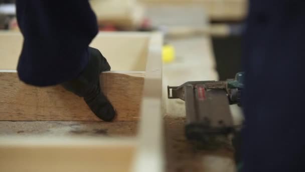 Young Man Dark Coat Puts Together Wooden Pieces Sofa Stapler — Stock Video