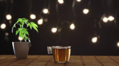 Çömlekçilik esrar bitki ile bambu tablo. Sıcak CBD çayı ve çaydanlık. Rahat arka plan.
