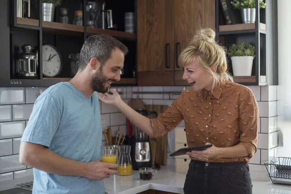 Sabah mutfakta bir çift. Tablette bir şey izlerken eğleniyorlar..