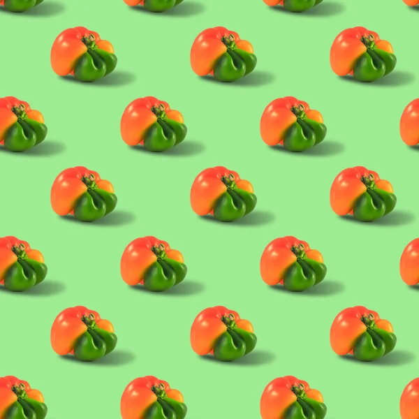 Pimenta laranja feio sem emenda padrão pimentas em um fundo verde — Fotografia de Stock