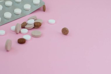 Pembe arka planda çeşitli ilaç hapları, haplar ve kapsüller. Üst Manzara. Düz yatıyordu. Uzayı kopyala Tıp konsepti. Pembe arka planda bir sürü hap.
