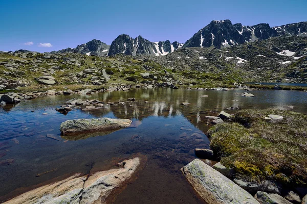 landscape with rocks and snowed mountains in Andorran Pyreenes