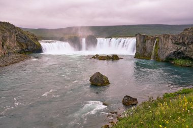 Yeşil alanları ve İzlanda 'daki güzel kayaları olan Godafoss şelalesinin muhteşem manzarası.