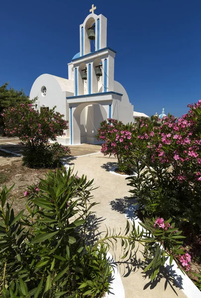 En typisk blå kupol kyrka ligger i Exo Gonia på den grekiska ön Santorini. — Stockfoto