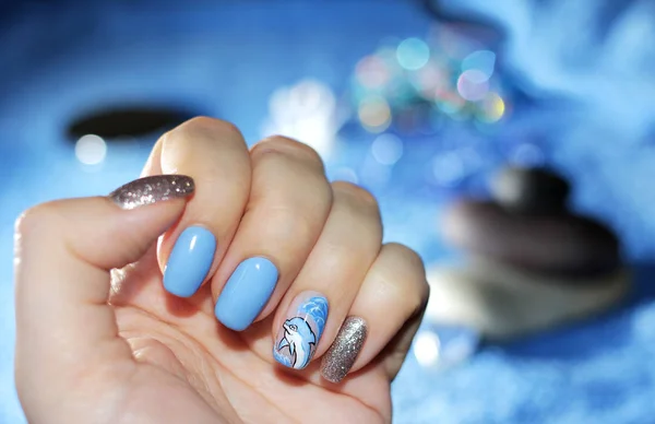 Nautical manicure with a dolphin pattern — Stock Photo, Image