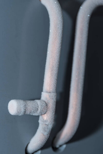 Ice on the metal pipes of a refrigeration plant - closeup cooling system