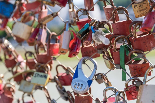 Locks as a love symbol on a bridge railing in Salzburg
