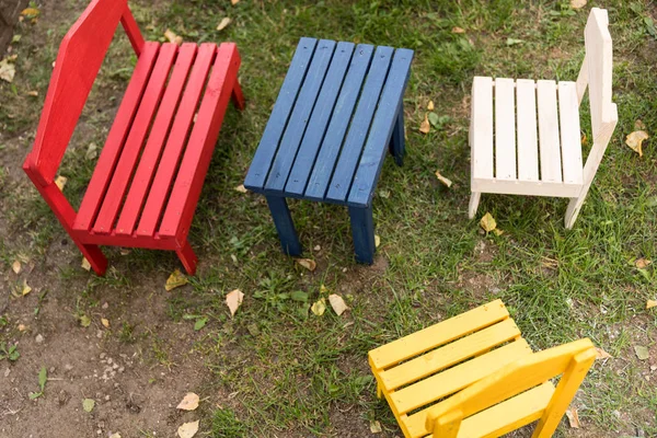 colorful wooden furniture for children set up in the garden - birds eye view