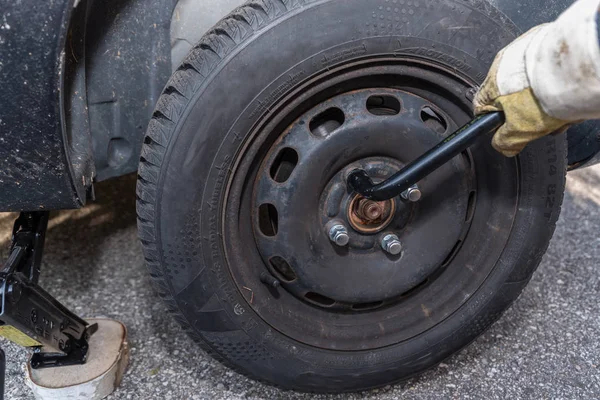 Even car tires change with jack - closeup flat tire