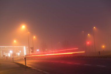 Bad driving conditions due to fog at night clipart