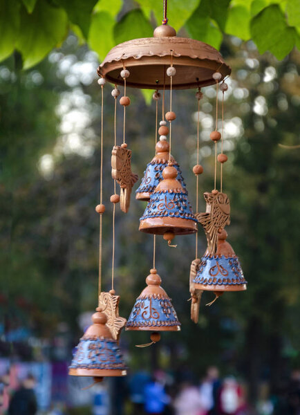 The composition of ceramic bells and fish that hang on the threads
