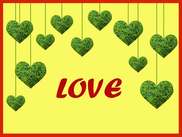 Green decorative hearts from living plants hang on threads on a yellow background, space for text.