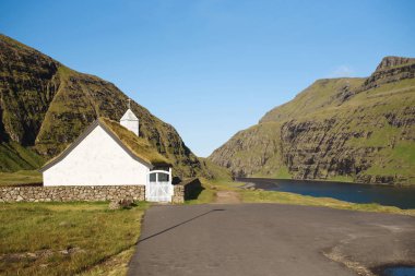 Saksun church old building at lake in mountains on Faroe Islands clipart