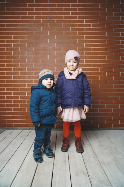 Sister Holding Brother Hand Brick Wall — Stock Photo, Image