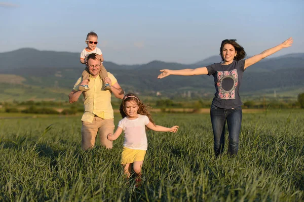 Família Feliz Correndo Campo Pôr Sol — Fotografia de Stock