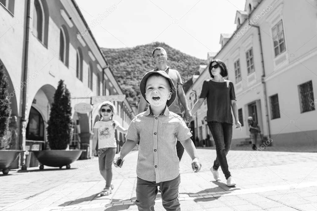 boy and his family walking in street in sunlight