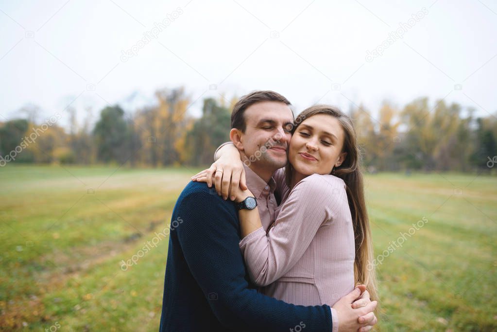 woman and loving man outdoors in park, couple hugging 