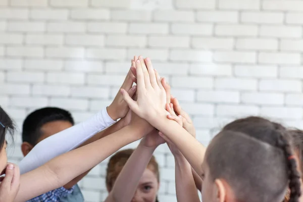 Kids hand assemble as a connection meeting teamwork concept. Tea