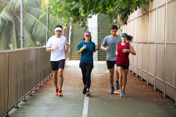 Healthy group of people jogging on track