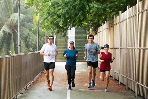 Healthy group of people jogging on track