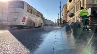 Rusya, Sankt-Petersburg, 03 Nisan 2019: güneşli bahar gününde kış sonrası şehir temizliği, Belediye hizmeti sokakları ve kaldırımları yıkıyor, Tulum, özel ekipman, bu yayalar bir sürü