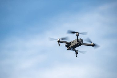 Gökyüzünde uçan dron, beyaz bulutlu mavi gökyüzü, güneşli hava, dönen pervaneler, hiç kimse
