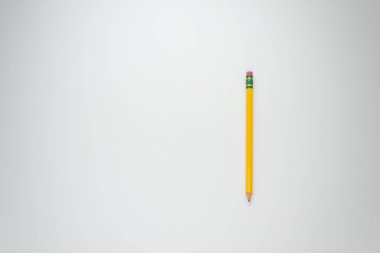 Okula geri dönmek ve beyaz bir arka plan aleyhine çalışmak için sarı kalem.