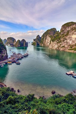 Tourist Junks in Halong Bay,Panoramic view of sunset in Halong Bay, Vietnam, Southeast Asia,UNESCO World Heritage Site clipart