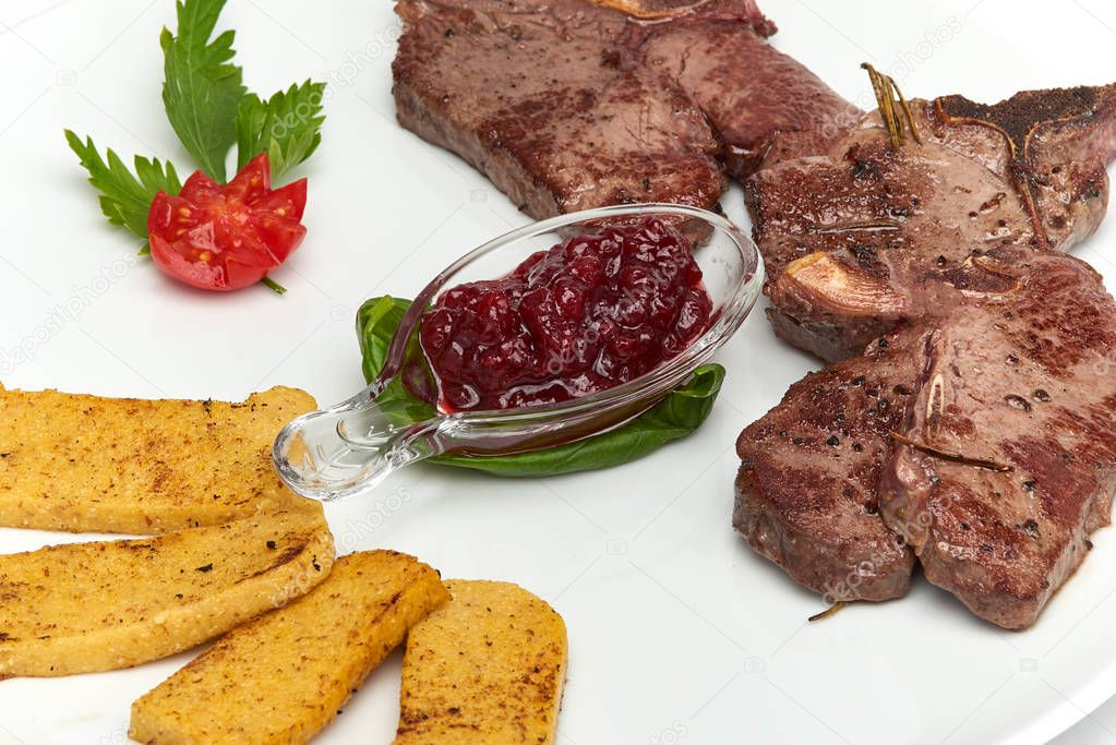 Italian food, Deer ribs with grilled polenta served on white plate, isolated on white background